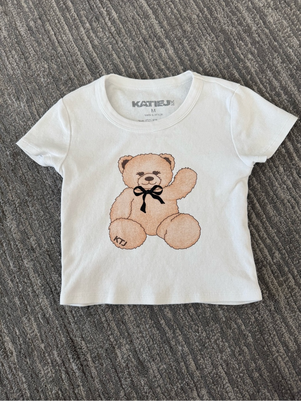 Katie J Waving Teddy Bear Graphic Baby Tee With Black Bow